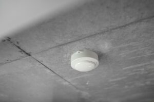 Fire alarm smoke detector on a commercial ceiling