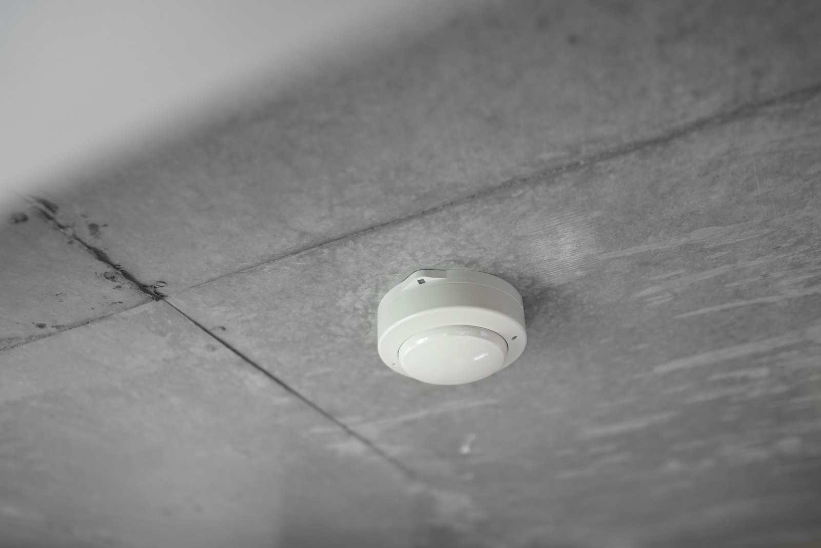 Fire alarm smoke detector on a commercial ceiling