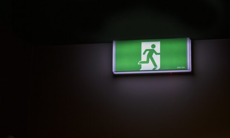 Illuminated fire exit sign in a business