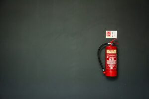 Red fire extinguisher mounted on a wall