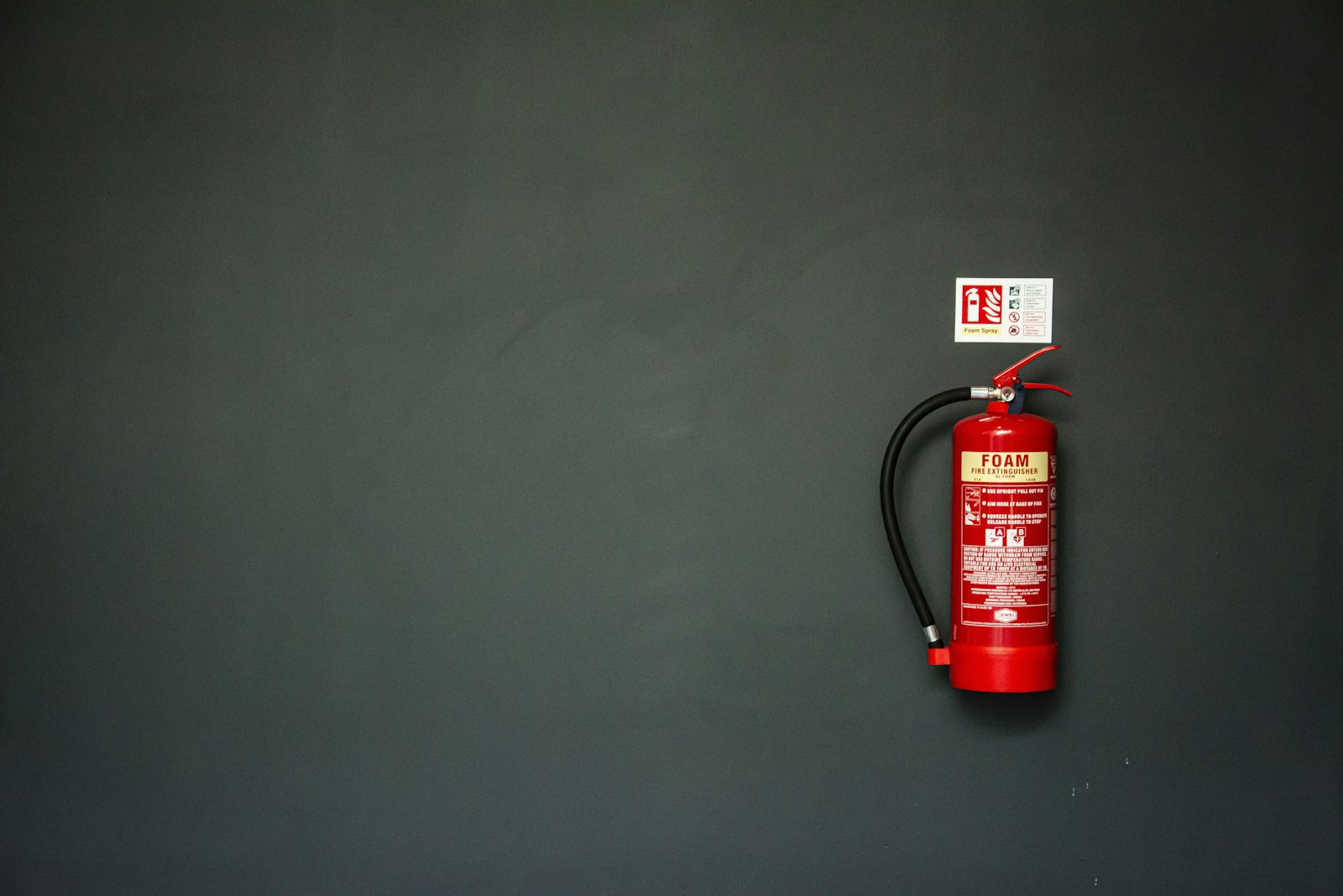 Red fire extinguisher mounted on a wall
