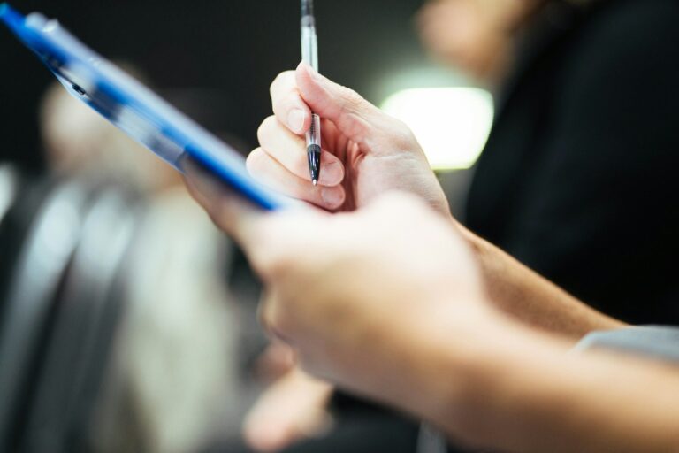 Signing Form 12A BWOF paperwork on a clipboard